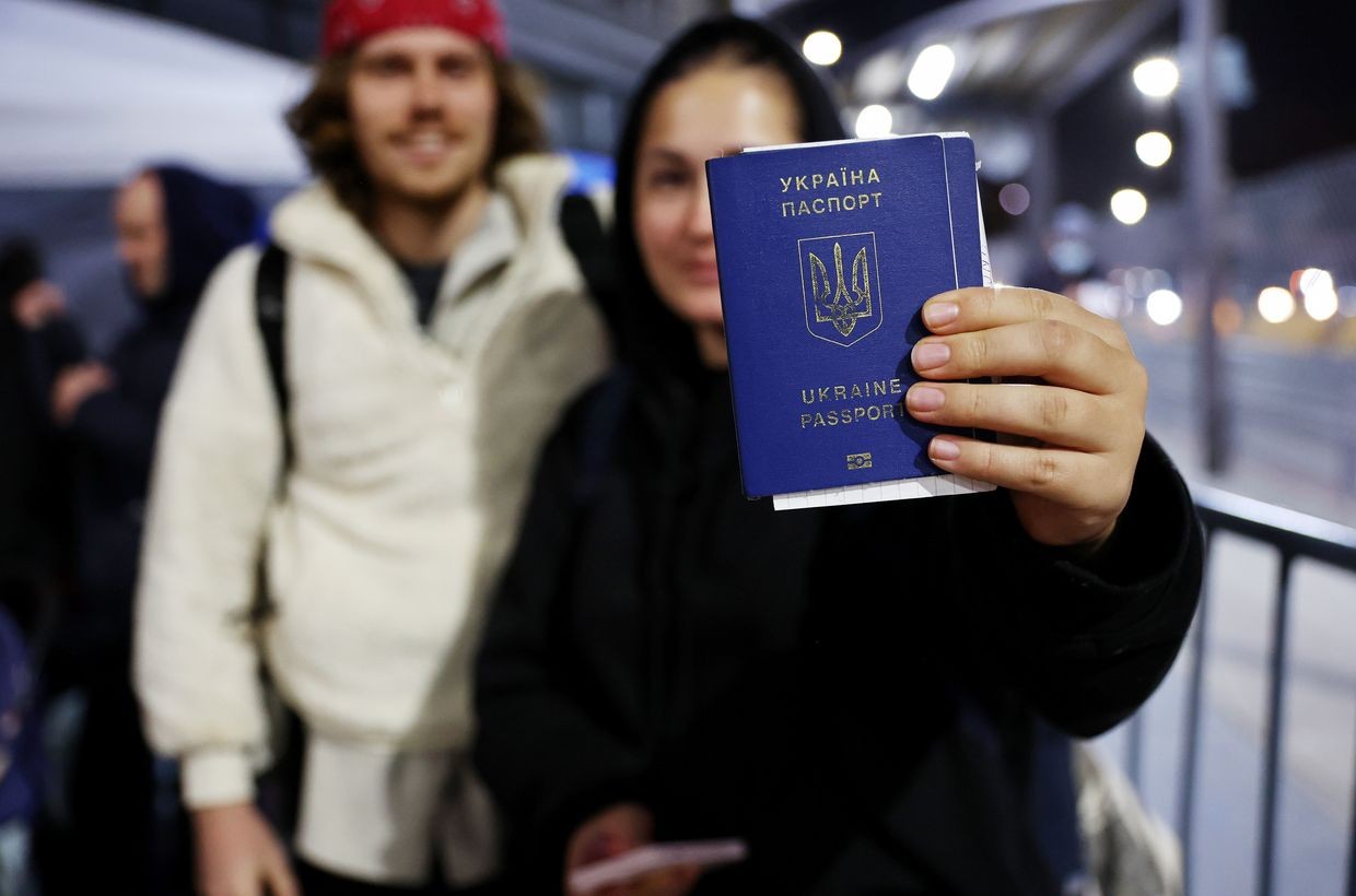 A woman holds a Ukrainian passport at the San Ysidro Port of Entry in Tijuana, Mexico, on April 5, 2022
