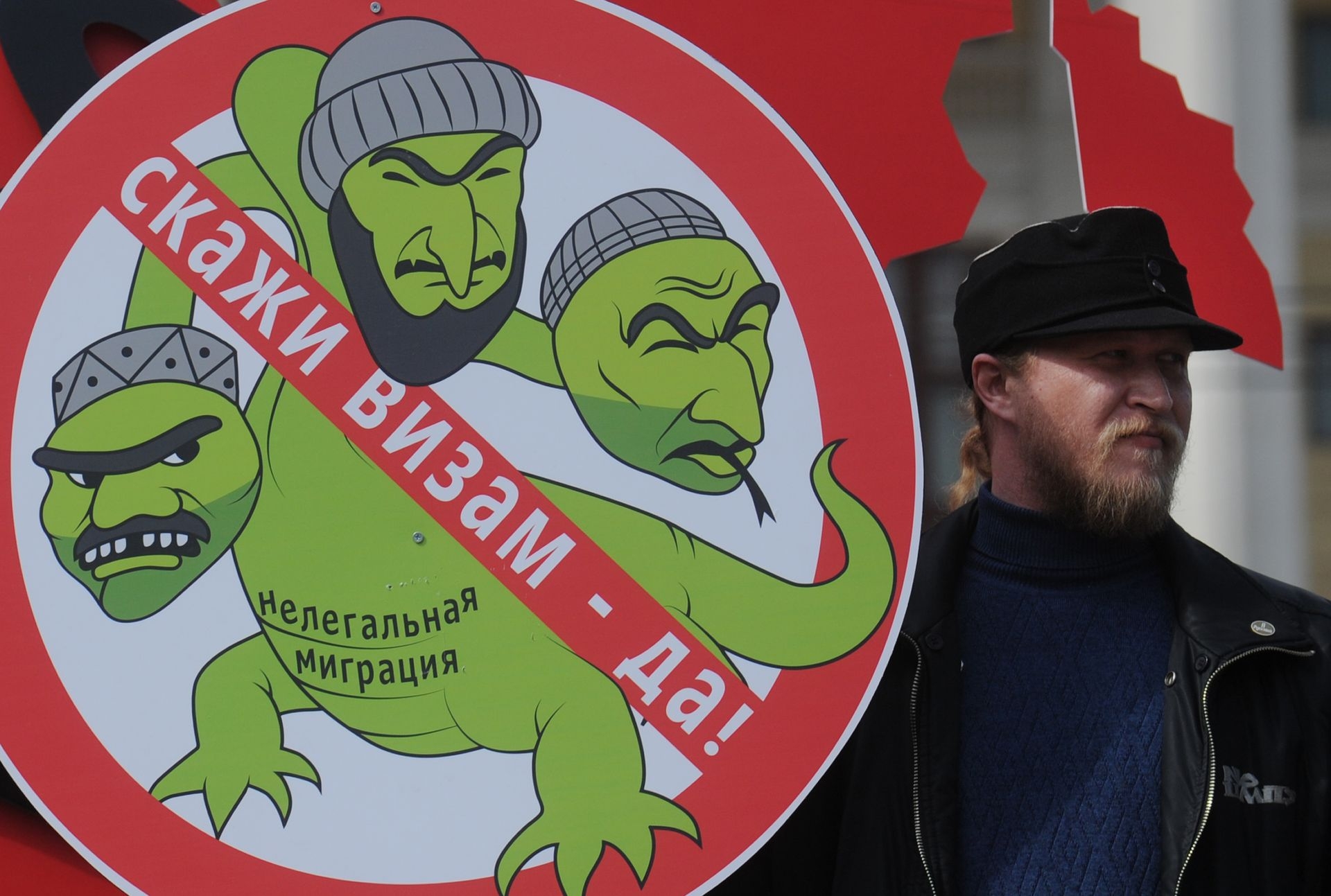 A russian man holds a poster reading “Say yes to visas!” during a rally against illegal immigration from Central Asia in Moscow, Russia, on April 14, 2013. 