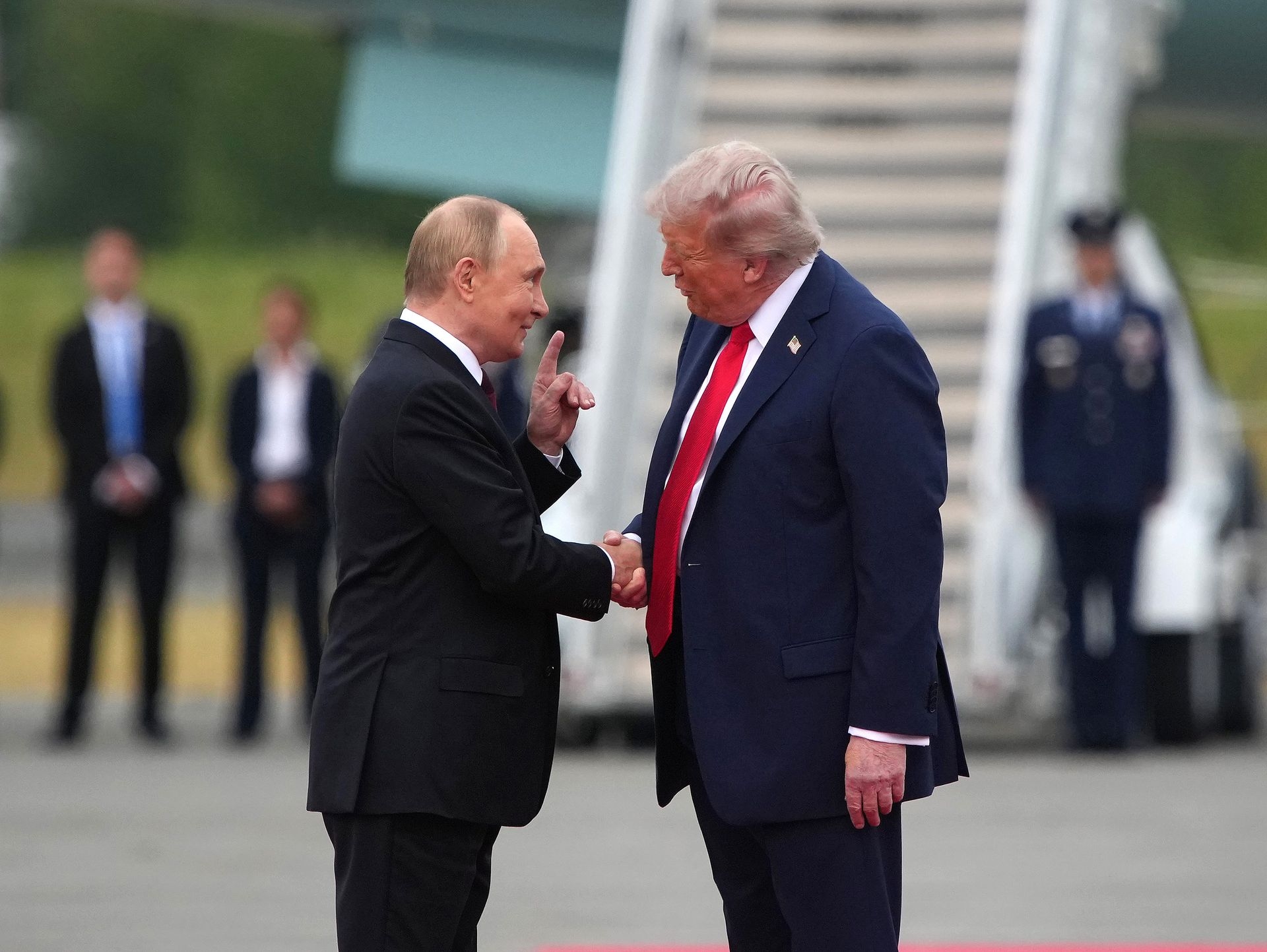 U.S. President Donald Trump (R) greets Russian President Vladimir Putin (L) upon his arrival at Joint Base Elmendorf-Richardson in Anchorage, Alaska, U.S. on Aug. 15, 2025.